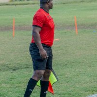 A match official monitors play during the UTECH vs NCU female football competition.