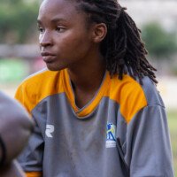 A NCU player sits on the sidelines during Half-Time at the female football match against UTech.