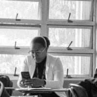 A university lecturer checks her phone while in class.